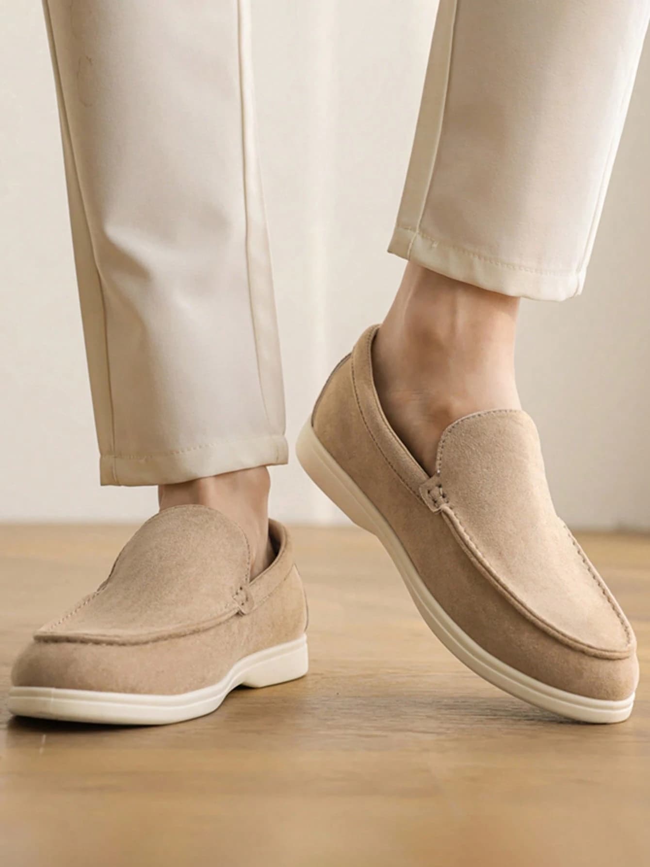 A side view of the same loafers being worn, showing the moccasin stitching.