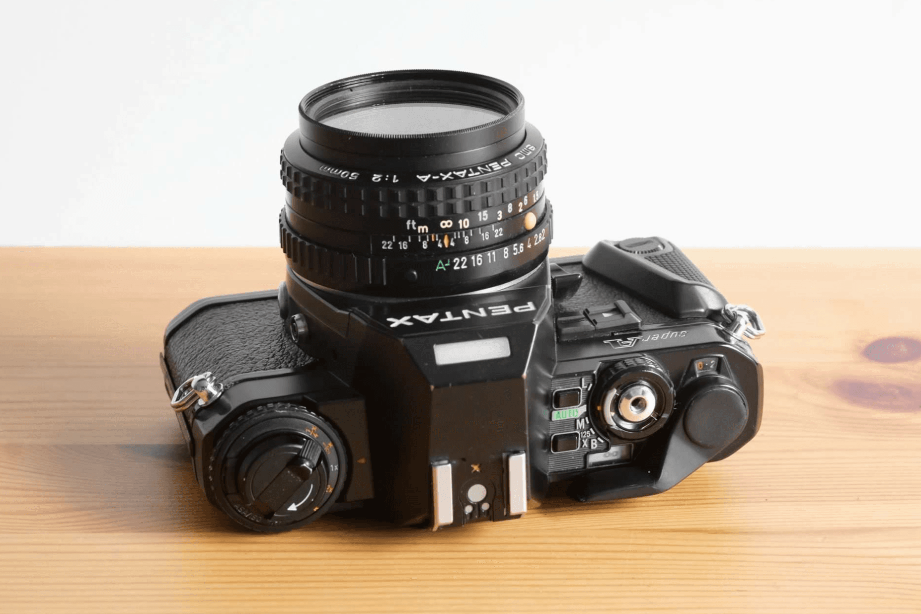 Top view of the same Pentax Super A, showing the mode dial, shutter button and film-speed controls.
