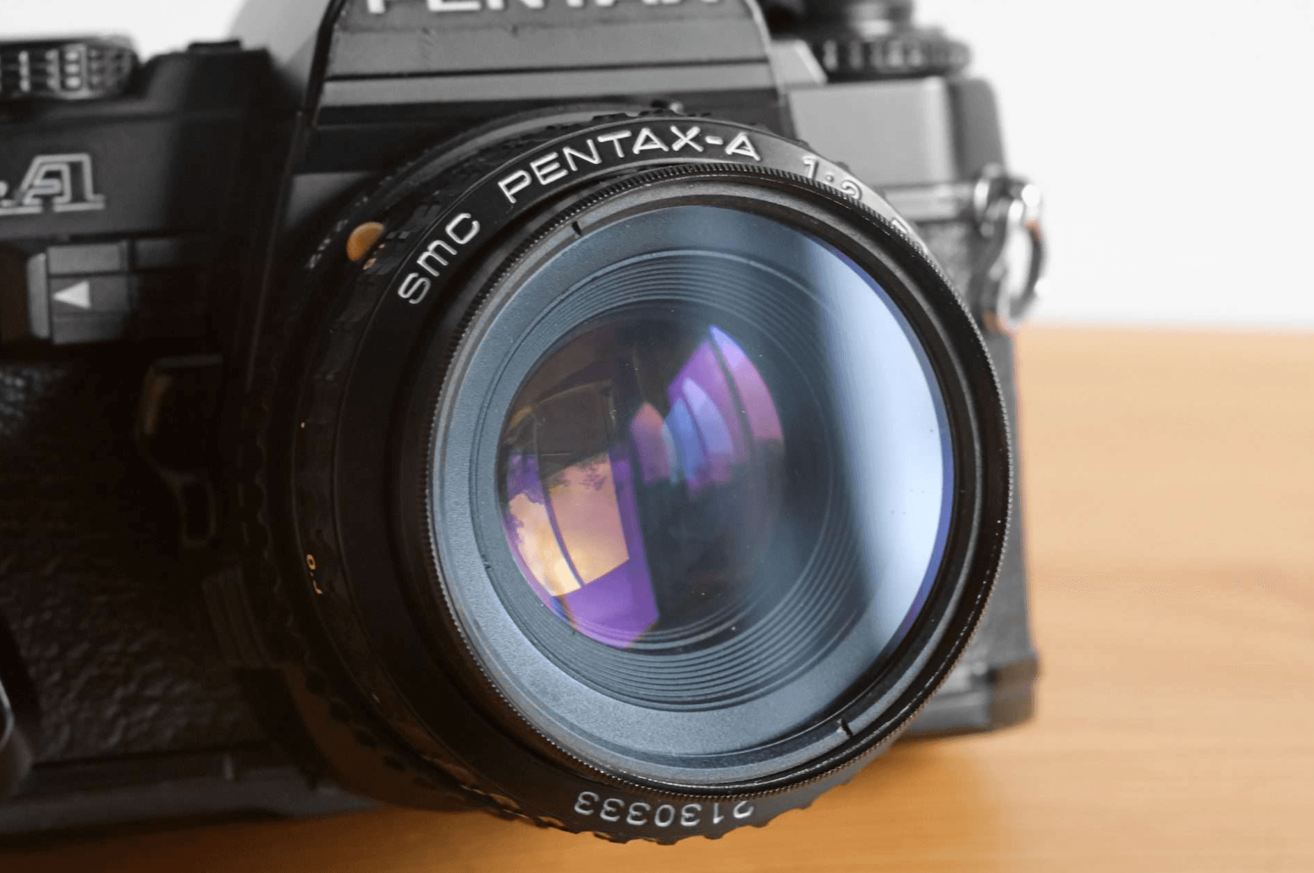 Close-up of the Pentax Super A's SMC Pentax-A 50mm f/2 lens.